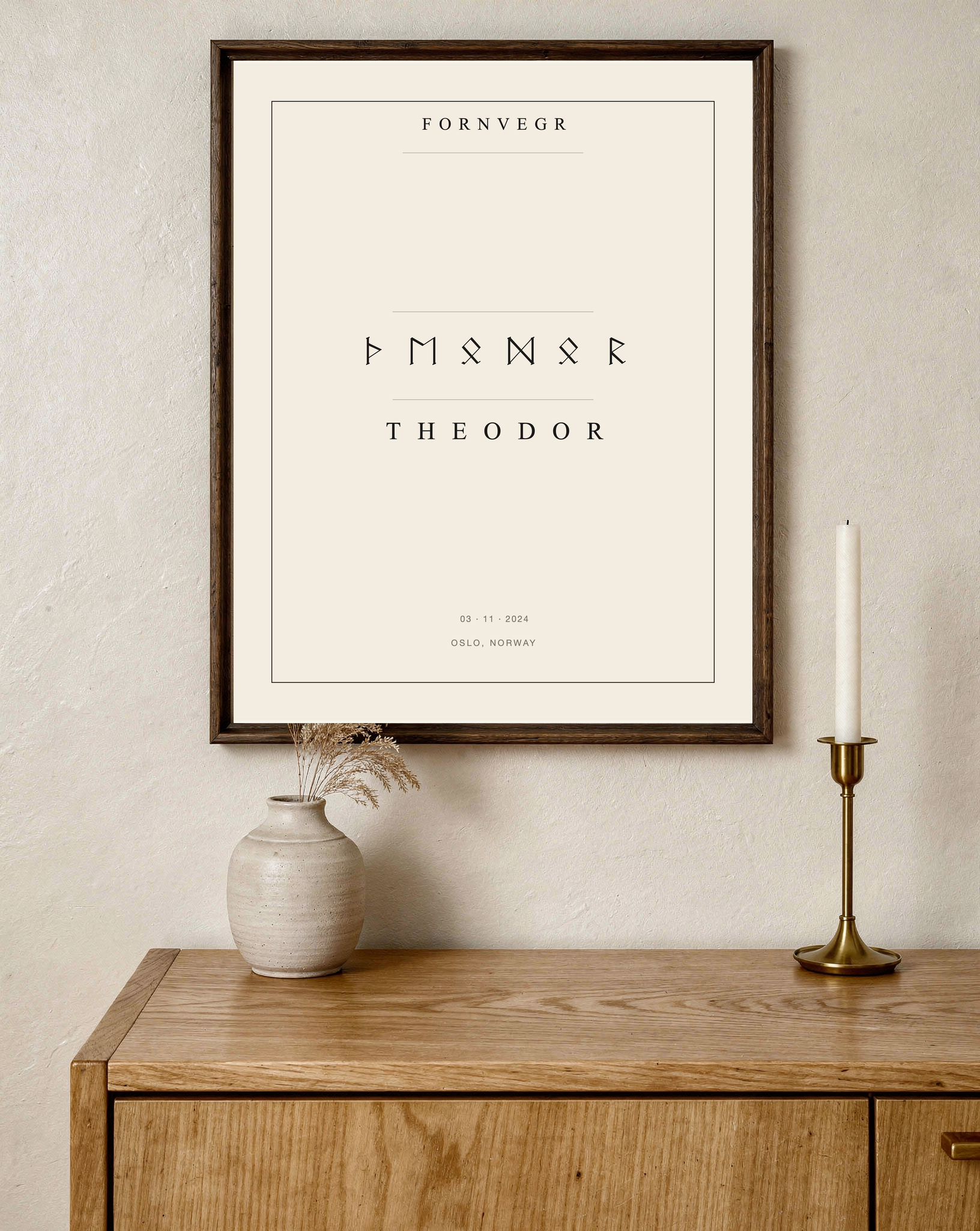 Personalized Elder Futhark Name Print in a dark wood frame on a quiet living room wall
